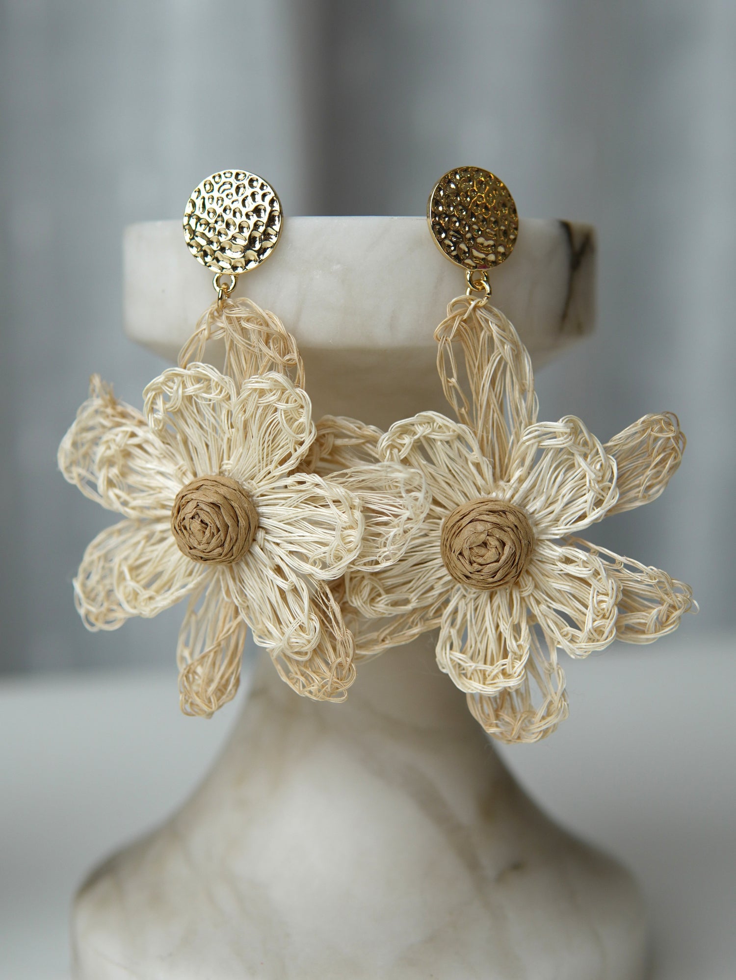 All Above Boutique natural straw flower dangle earrings with gold textured studs.