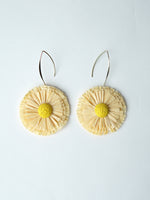 All Above Boutique natural straw flower earrings with yellow center and silver hooks. Boho statement jewelry.