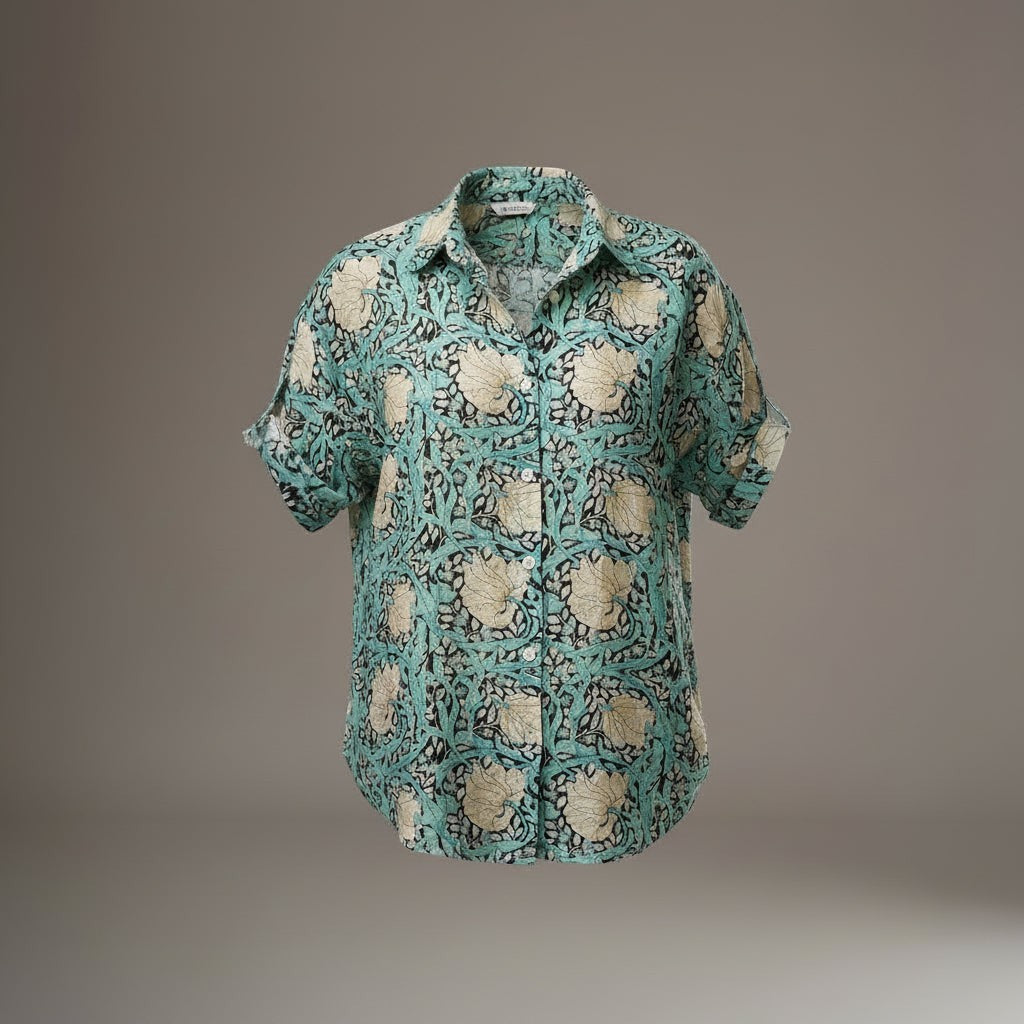 All Above Boutique light teal rayon shirt with a cream floral print, short sleeves, and an asymmetric hem.