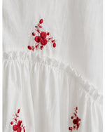 All Above Boutique white cotton blend oversized shirt with red floral embroidery and ruffled details.