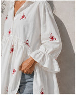 All Above Boutique white cotton blend oversized shirt with red floral embroidery and ruffled 3/4 sleeves.