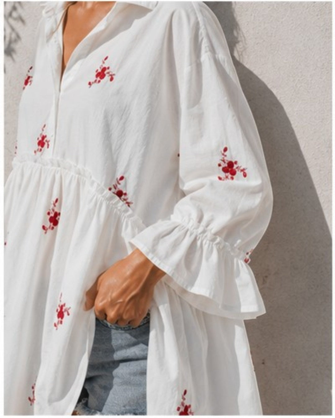 All Above Boutique white cotton blend oversized shirt with red floral embroidery and ruffled 3/4 sleeves.