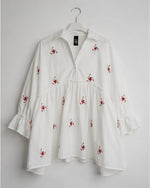 All Above Boutique white cotton blend oversized shirt with red floral embroidery and 3/4 ruffled sleeves.