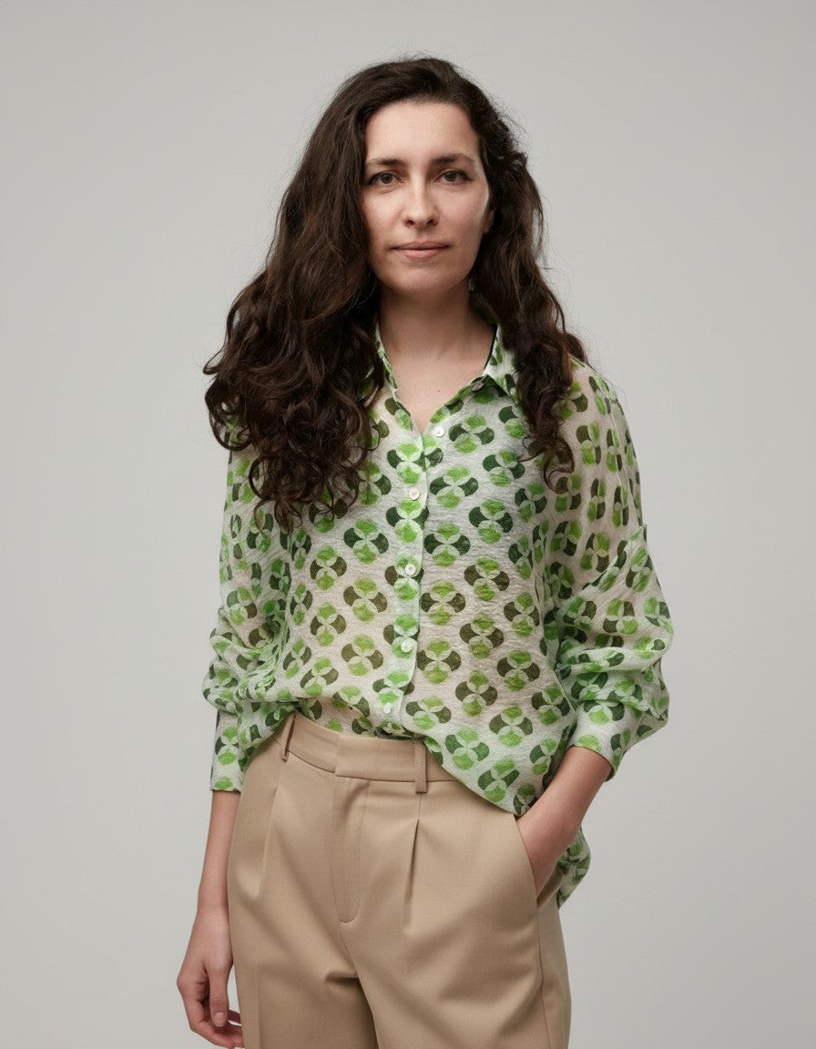 All Above Boutique white rayon shirt with green clover print, classic collar, long sleeves, and front buttons. Relaxed fit.