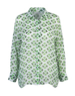 All Above Boutique white rayon shirt with green clover print, classic collar, long sleeves, and asymmetric hem.