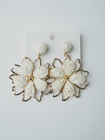 All Above Boutique white woven straw flower earrings with gold frame, boho chic style.