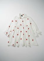 All Above Boutique white oversized shirt with 3/4 sleeves and a playful strawberry print. Features a ruffled hem and collar.