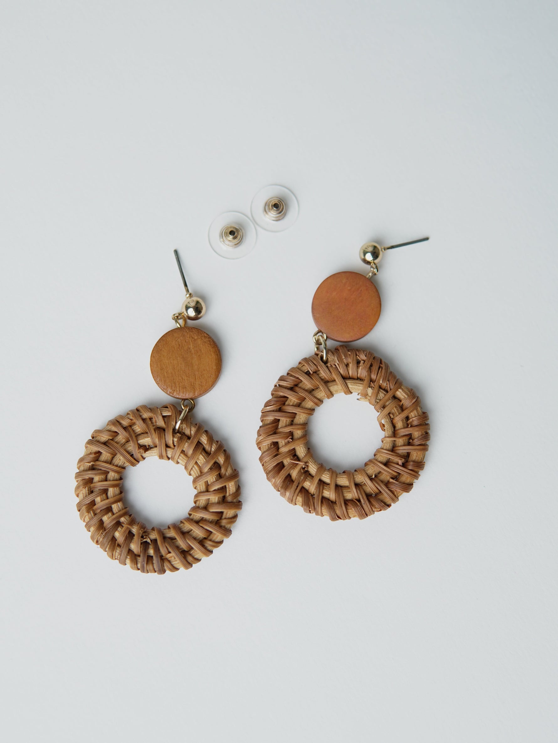 All Above Boutique boho style natural wood woven hoop earrings with wooden disc accent.
