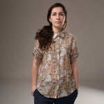All Above Boutique women's loose-fit rayon floral print shirt with short sleeves and an asymmetric hem in yellow and blue.