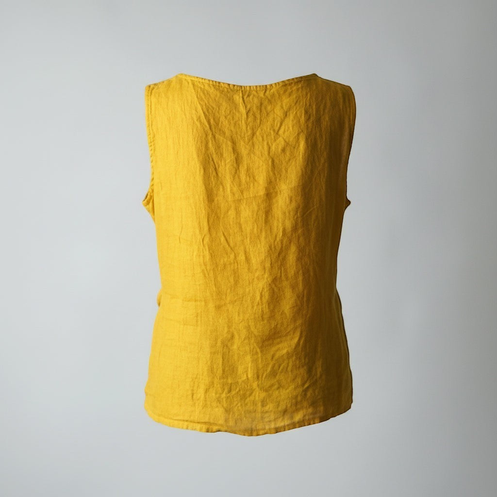 All Above Boutique mustard yellow linen sleeveless top with a tie knot detail at the waist. Relaxed fit, ideal for summer.