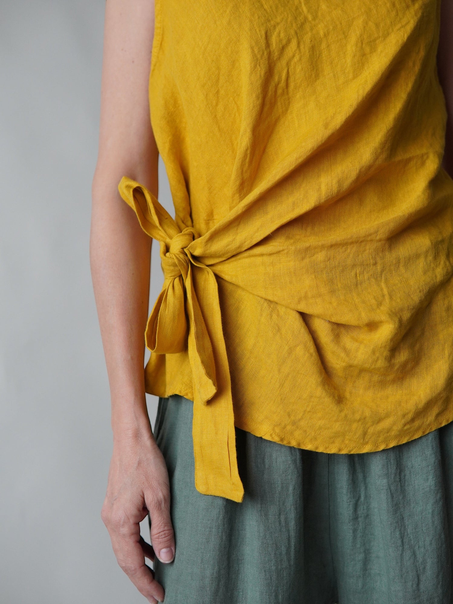 All Above Boutique mustard yellow linen sleeveless tie-waist top
