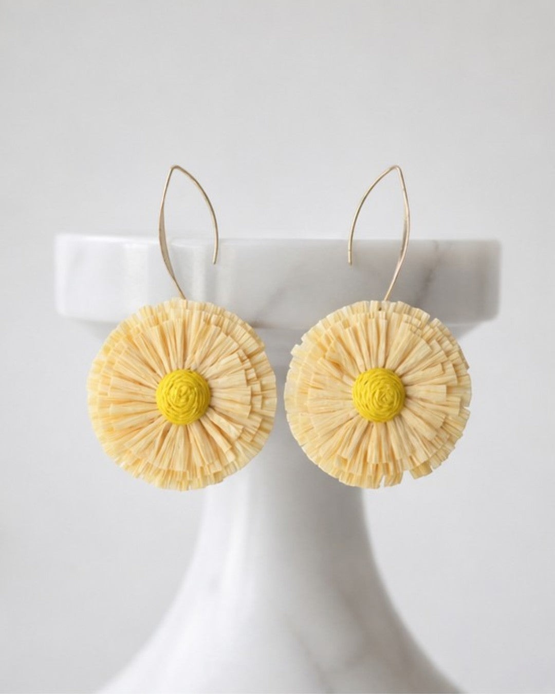 All Above Boutique yellow raffia flower statement boho earrings with gold hooks.