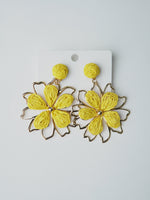 All Above Boutique yellow double flower straw earrings with gold frame, boho chic style.