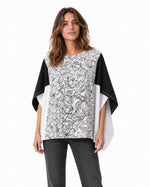 Bluză fluture cu panou floral alb-negru și inserții negre și albe, vedere din față pe model - All Above Boutique