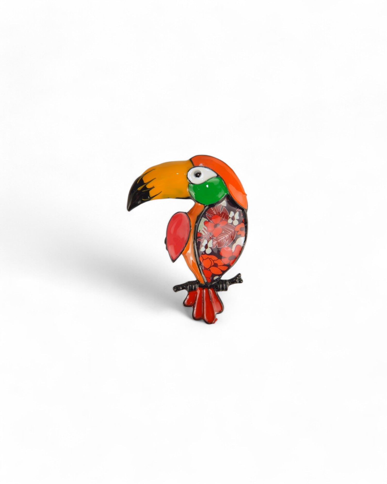 Broșă portocalie tucano, cu accente vibrante și detalii florale.