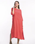 All Above Boutique coral linen midi dress with side buttons and 3/4 sleeves. Model is wearing a casual summer dress.